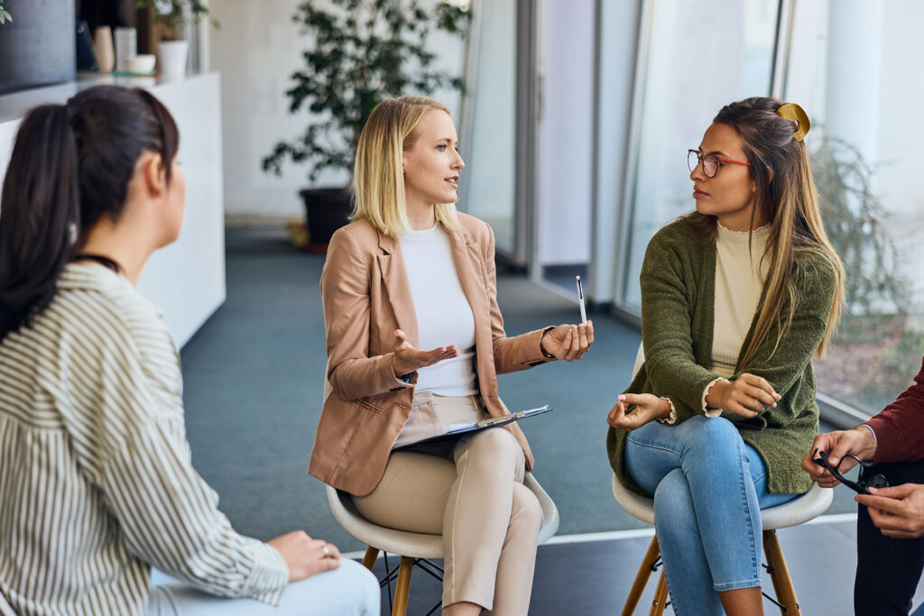Group of women discussing ideas during a teamwork session in a bright office